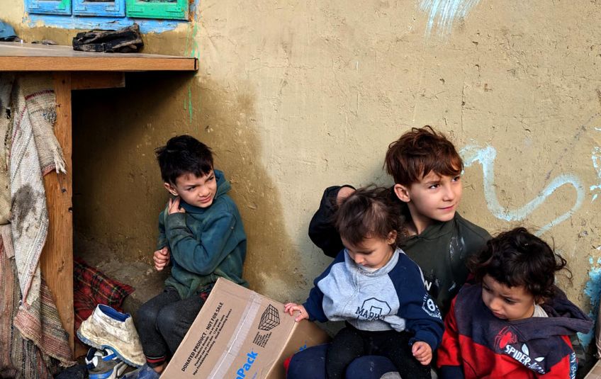 four young children on street with FMSC box in Ukraine.