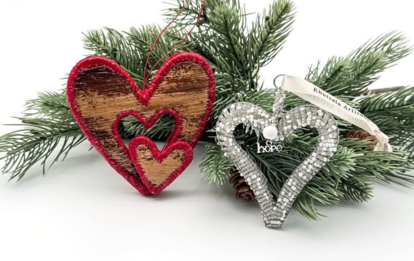 Red and silver heart shaped ornaments with evergreen branch