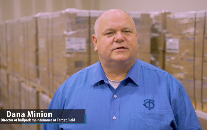 Man in blue shirt with Twins logo with boxes