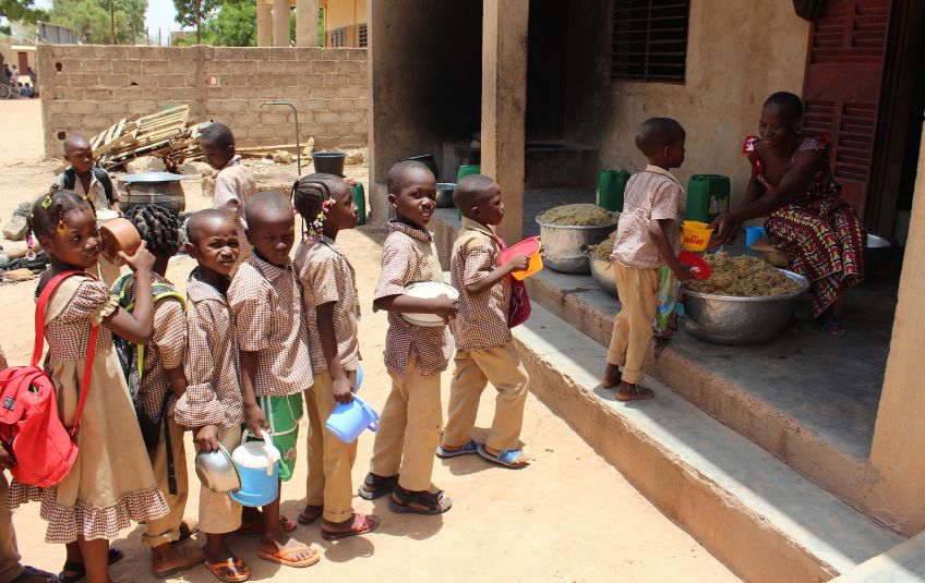children in Burkina Faso line up for FMSC food