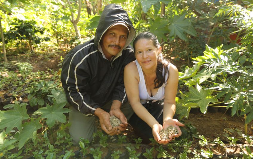 Two people holding locally grown grain for MannaPack Mix